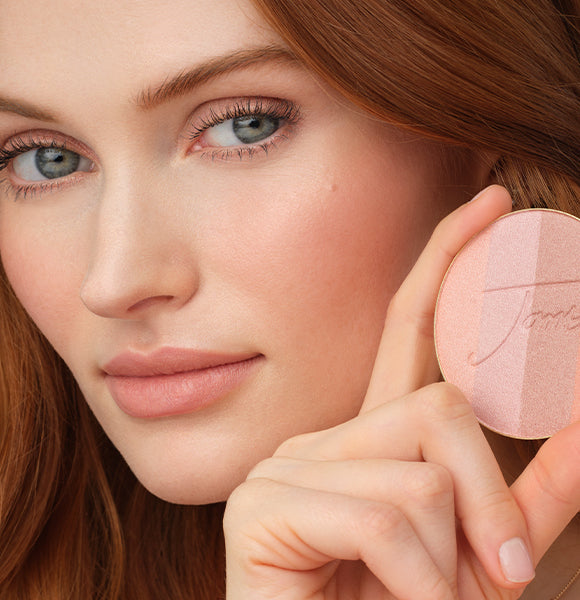 image of woman smiling wearing bronzed makeup
