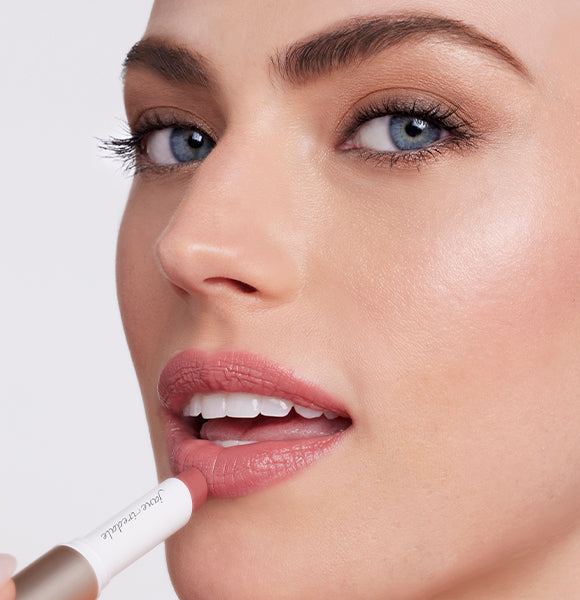 a woman applying eye shadow