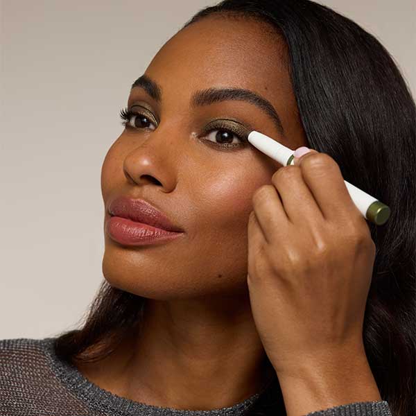 woman putting on stick eyeshadow