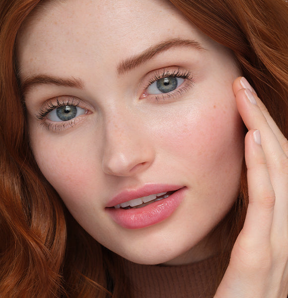 image of woman smiling wearing bronzed makeup