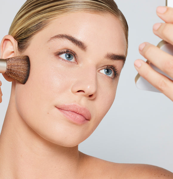 a model applying purepressed base with a handi brush