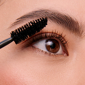 image of woman applying eye makeup