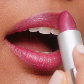 image of woman applying lip makeup
